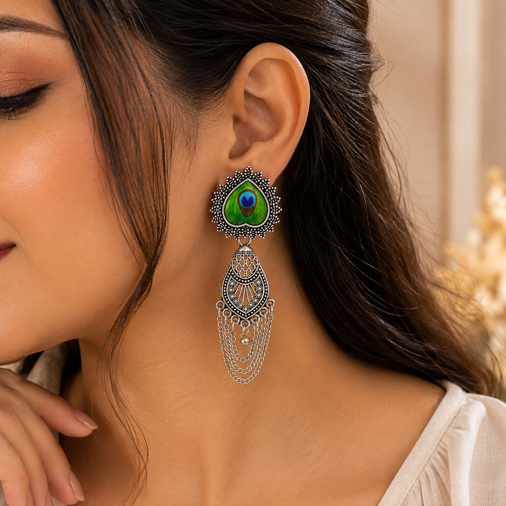 Peacock earrings worn by model