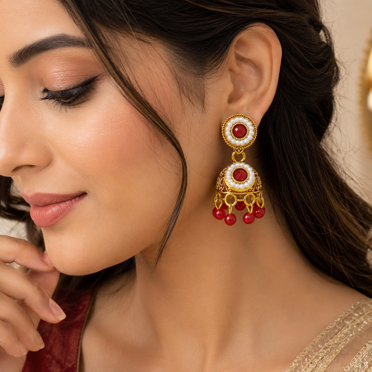 Model wearing red pearl jhumka earring