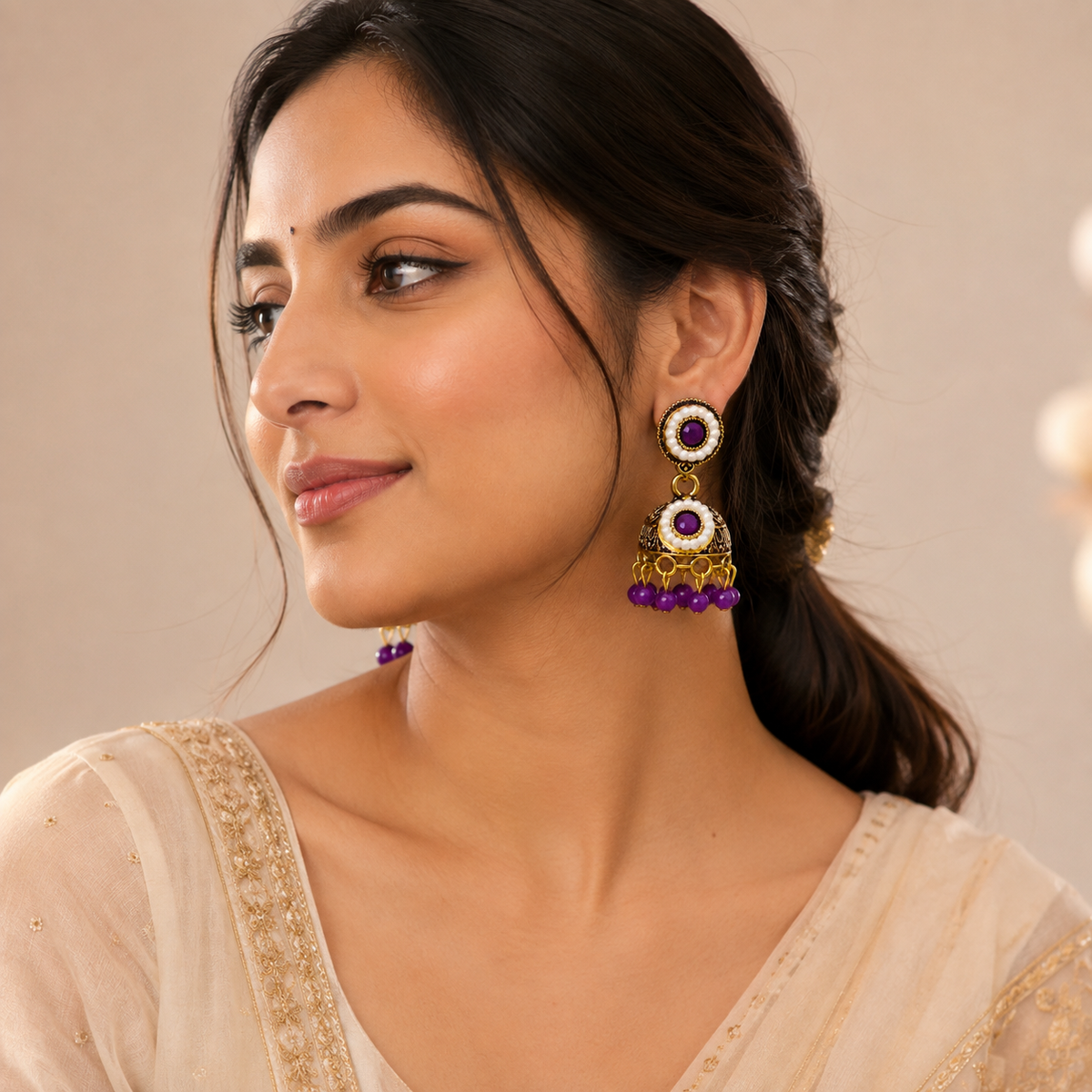 Model wearing purple jhumka earrings