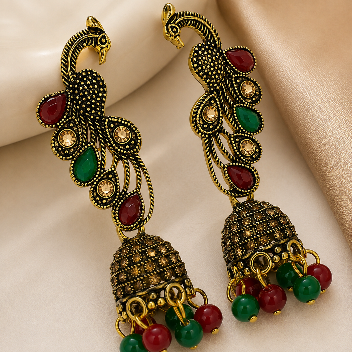 Close-up details of red green peacock jhumka earrings