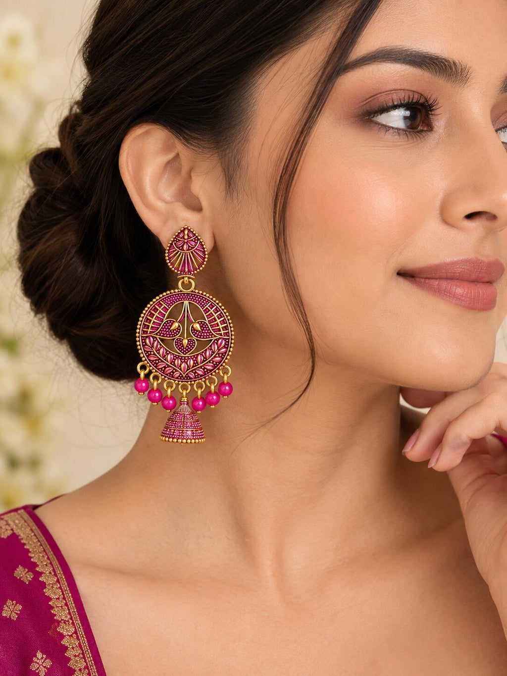Model wearing pink and gold round jhumka drop earrings