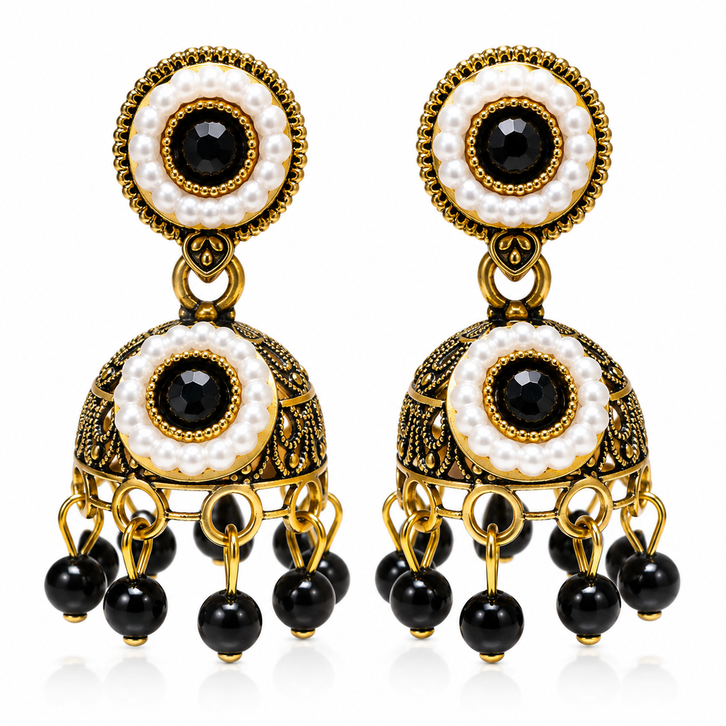 Black stone and pearl-style antique-gold jhumka earrings against white background